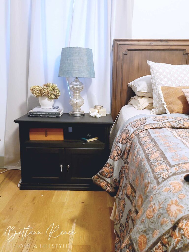 repurposed bedroom nightstand styled with mercury glass lamp