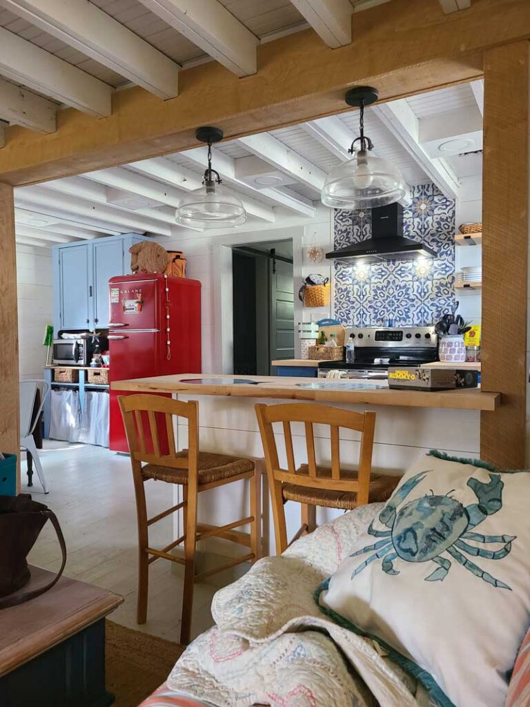 There’s something about summer at the beach that feels slower, softer, and more sacred. Our 1930s beach cottage has become a place of rest and restoration — a quiet escape where time feels different and the simplest things bring the most joy.

As the season begins to wind down and our final summer visits approach, I thought it was the perfect time to share a peek inside. I haven’t talked much about the beach house lately, but this sweet little cottage has become such a special part of our lives. Before summer slips away entirely, I wanted to document the simple, seasonal details that make this space feel like our version of home by the sea.

A Little History

Our beach cottage dates back to the 1930s. It’s small and unassuming — full of quirks, creaky floors, and slanted ceilings. But it has a soul. When we first found it, I knew immediately it could become something beautiful with the right touches. Over time, we’ve slowly updated, painted, rearranged, and layered in things that feel meaningful — many of them thrifted, handed down, or collected during our coastal stays.

This home isn’t perfect, and it isn’t finished — but that’s part of its charm. It’s the kind of place where sandy feet are welcome, books get finished in a day, and naps happen in the middle of the afternoon.

Our Summer Cottage Style: Coastal, Relaxed, and Timeless

The cottage isn’t decorated in a traditional nautical theme. You won’t find anchors or bright primary colors. Instead, we’ve leaned into a more timeless, relaxed coastal look that feels in line with the home’s age and character. Think:

Soft whites and creamy neutrals

Pale, beachy blues and watery greens

Linen curtains that catch the breeze

Woven baskets, vintage art, and natural textures

Weathered wood, rattan, and simple cotton throws

The goal was never to make the cottage look like a magazine — just a place that feels peaceful and personal.

Summer Touches That Make It Feel Special

This time of year, I don’t go overboard with seasonal decor, but I do love adding subtle summer touches that reflect the season without screaming “beach house.”

Here are a few simple things I’ve done this summer to make the space feel extra welcoming:

Fresh Flowers and Clippings from the Yard

Even at the beach, I try to bring a little life indoors — whether it’s hydrangeas, wildflowers, or a few branches in a glass jar.

Lightweight Linens and Breezy Textures

Linen table runners, cotton slipcovers, and light gauzy curtains keep everything feeling airy and fresh.

Bowls of Shells and Sea Glass

Rather than themed decor, I scatter small bowls with collected shells and beach finds. They’re subtle but meaningful reminders of time spent outside.

Well-Loved Books and Simple Vignettes

A stack of summer reads on the coffee table, a candle with a clean citrus scent, and a small basket of beach towels by the door — it’s the little things that make the cottage feel lived-in and loved.

Outdoor Spaces that Invite You to Linger

We have a small porch and a shady corner of the yard that are perfect for morning coffee or evening cocktails. In the summer, I keep them styled with comfy pillows, string lights, and citronella candles to stretch those outdoor moments just a bit longer.

The Beauty of Imperfection

One thing I’ve learned since owning this cottage is that nothing needs to be perfect to feel beautiful. The floors creak. The walls aren’t square. The furniture is a mix of hand-me-downs and thrifted finds. And yet… it feels like a retreat.

It reminds me that home doesn’t have to be polished — it just has to feel like you.

Looking Ahead

As summer begins to fade and we start thinking about fall routines, I’ll carry the feeling of this cottage with me: the slower mornings, open windows, and quiet simplicity. But for now, I’m soaking up every last bit of sunshine and savoring this season in our little slice of coastal calm.

If you’d like to see more of the cottage throughout the year or want a full tour room-by-room, let me know! I’d love to share more in future posts.